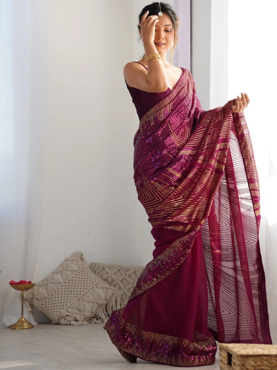 Woman wearing a purple saree with a white background