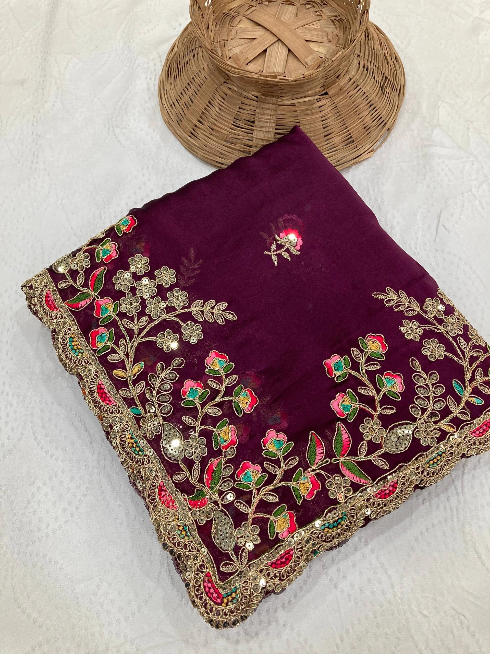 Embroidered purple fabric with floral patterns on a white background