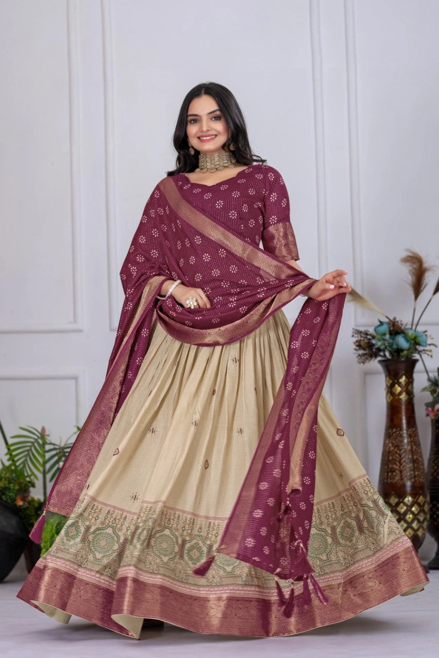 Woman wearing a maroon and beige traditional outfit with a matching dupatta.
