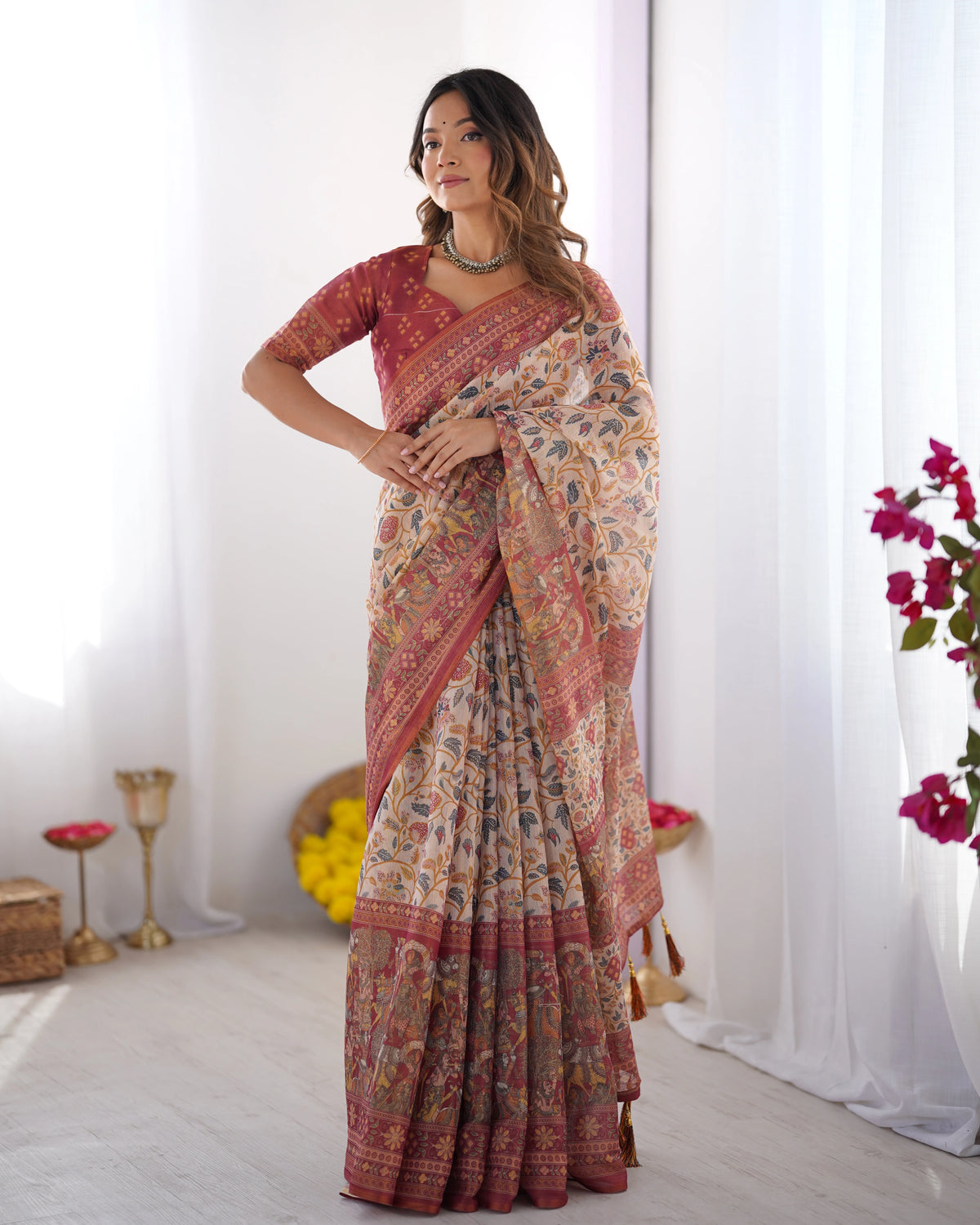 Woman wearing a patterned saree with a white background