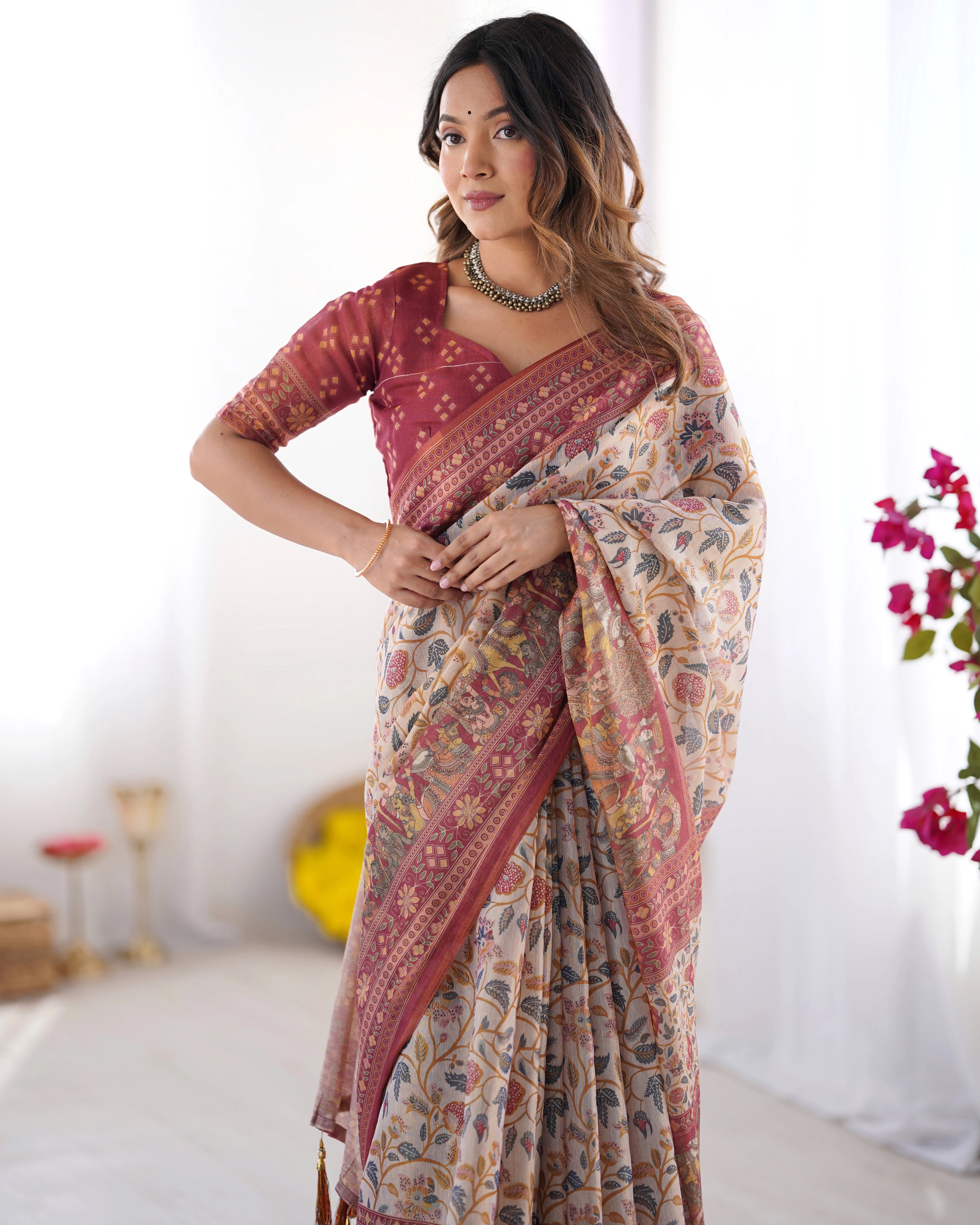 Woman wearing a patterned saree with a white background
