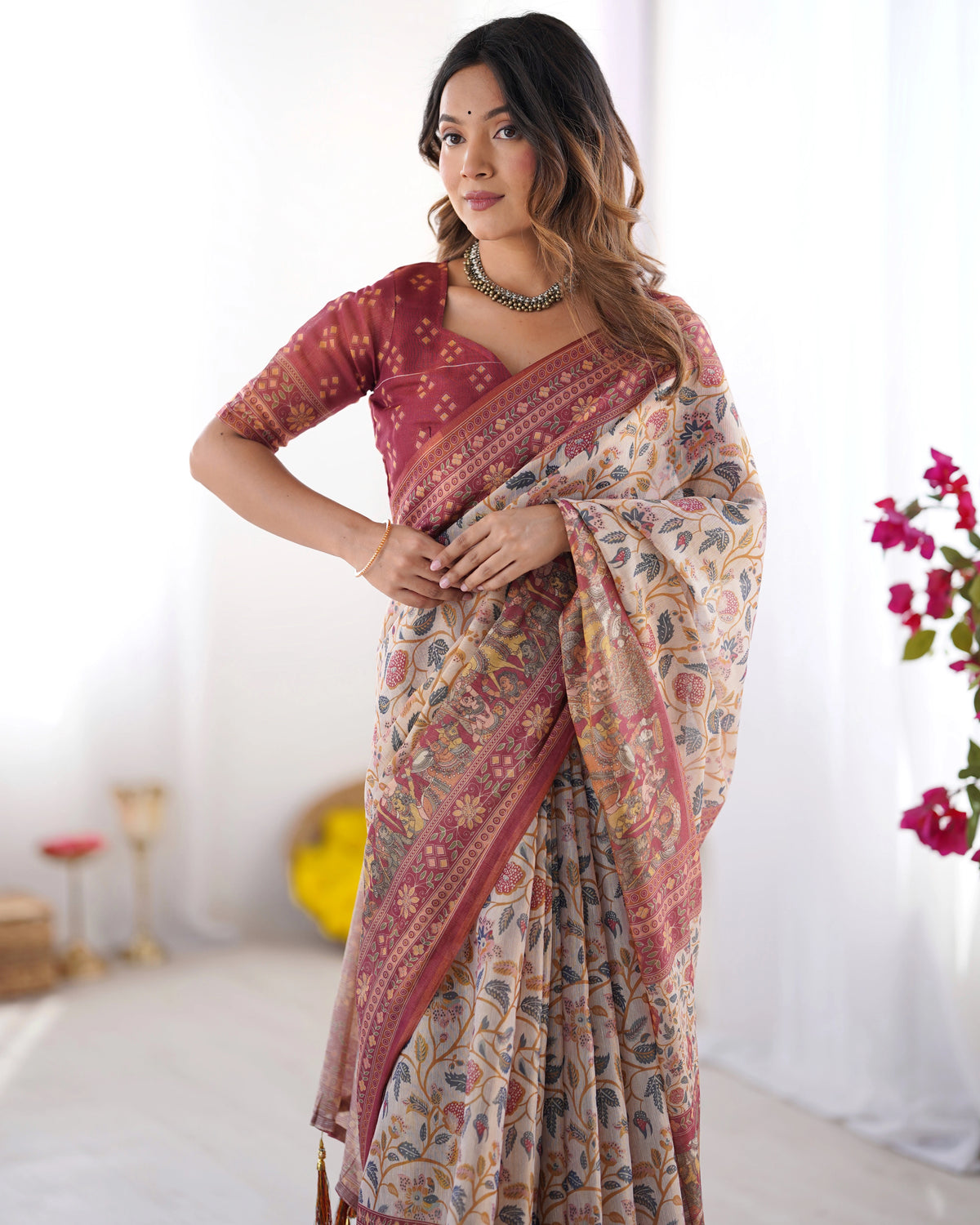 Woman wearing a patterned saree with a white background