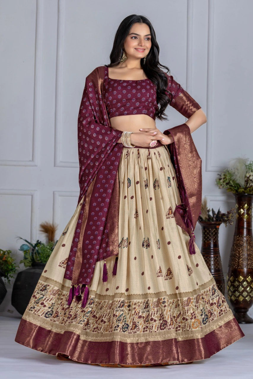 Woman wearing a maroon and beige traditional outfit with a matching dupatta against a neutral background.