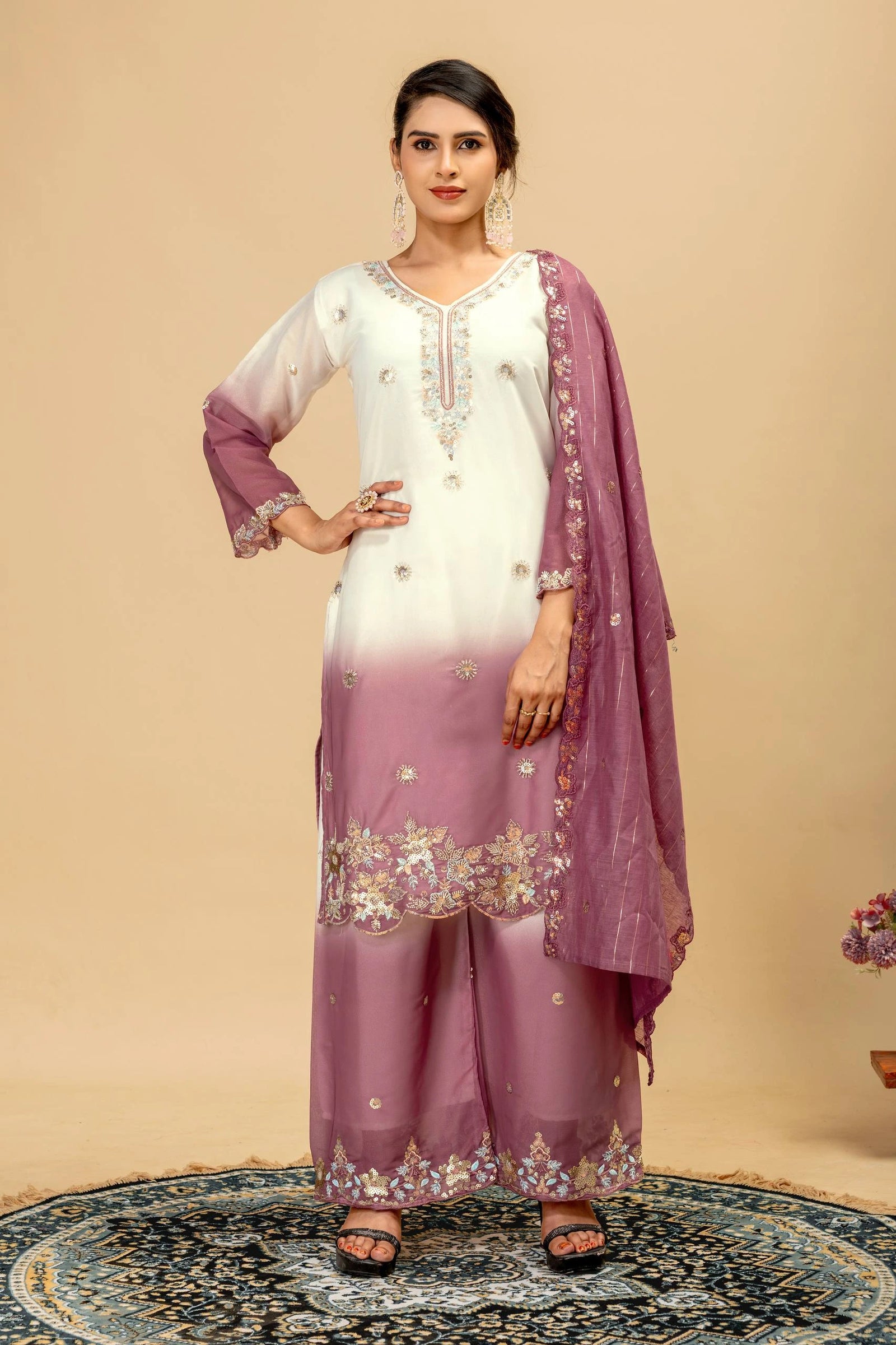 Woman wearing a white and purple traditional outfit with a matching dupatta on a beige background