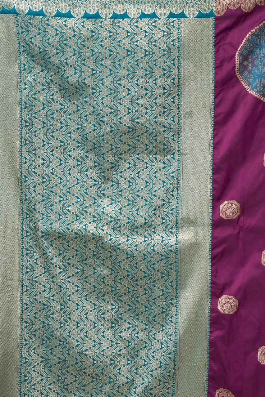 Fabric with a geometric pattern on one side and a solid color with decorative elements on the other, displayed against a white background.