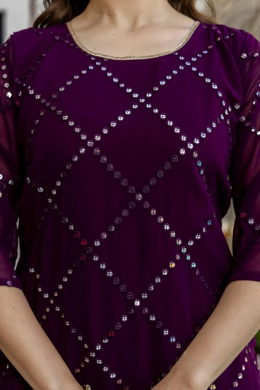 Purple top with diamond pattern of stones on a blurred background