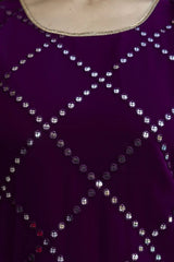 Close-up of a purple garment with silver bead detailing