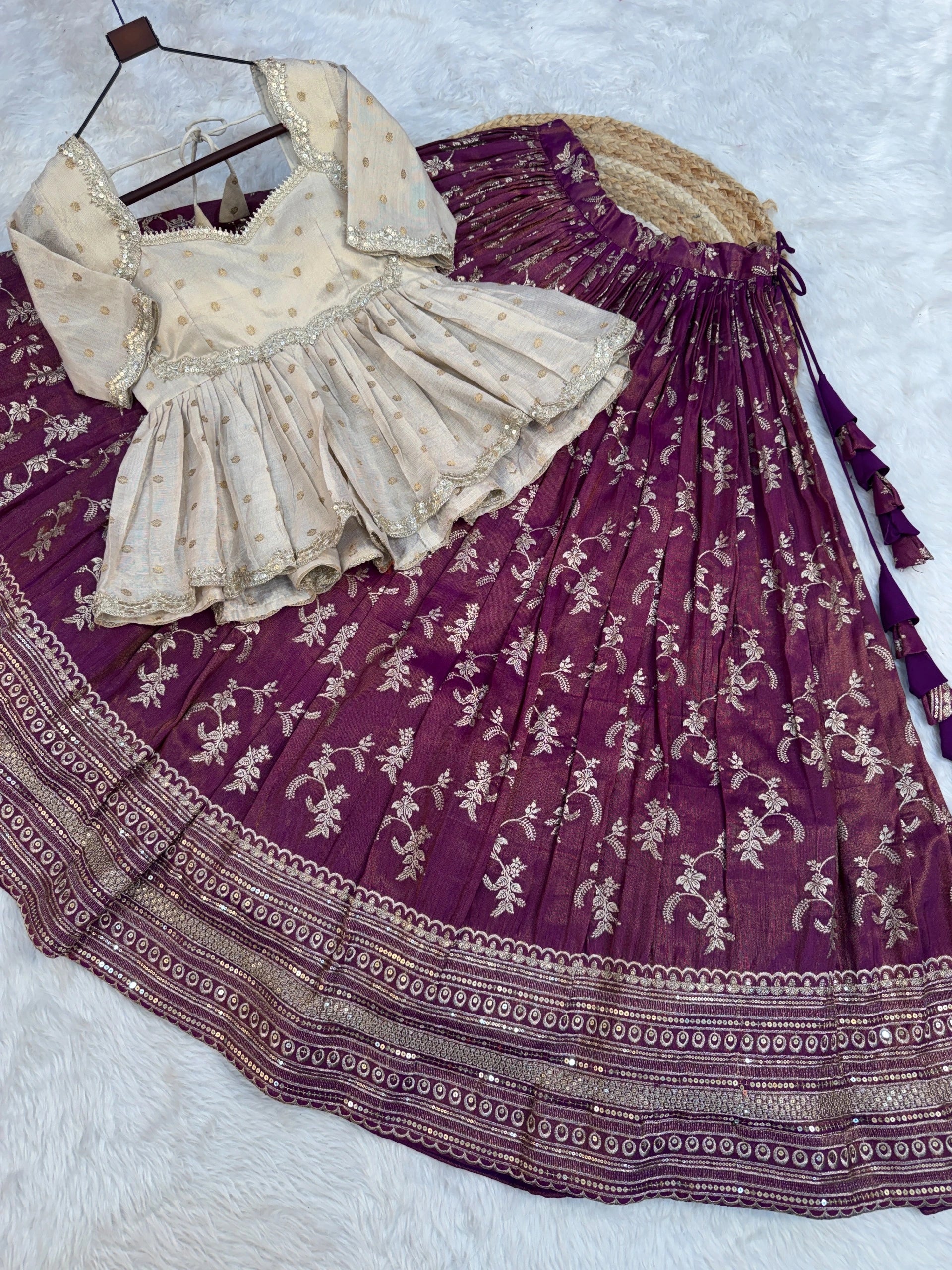 Purple embroidered skirt with a beige blouse on a white background