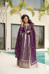Woman in a purple traditional outfit standing by a poolside.