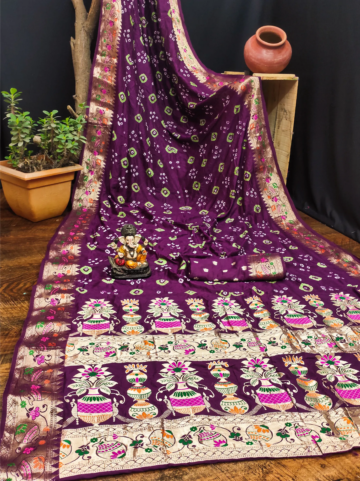 Purple saree with intricate patterns on a wooden surface