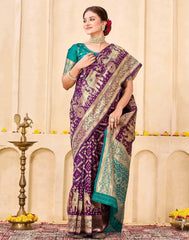 Woman wearing a purple and green saree with a decorative background