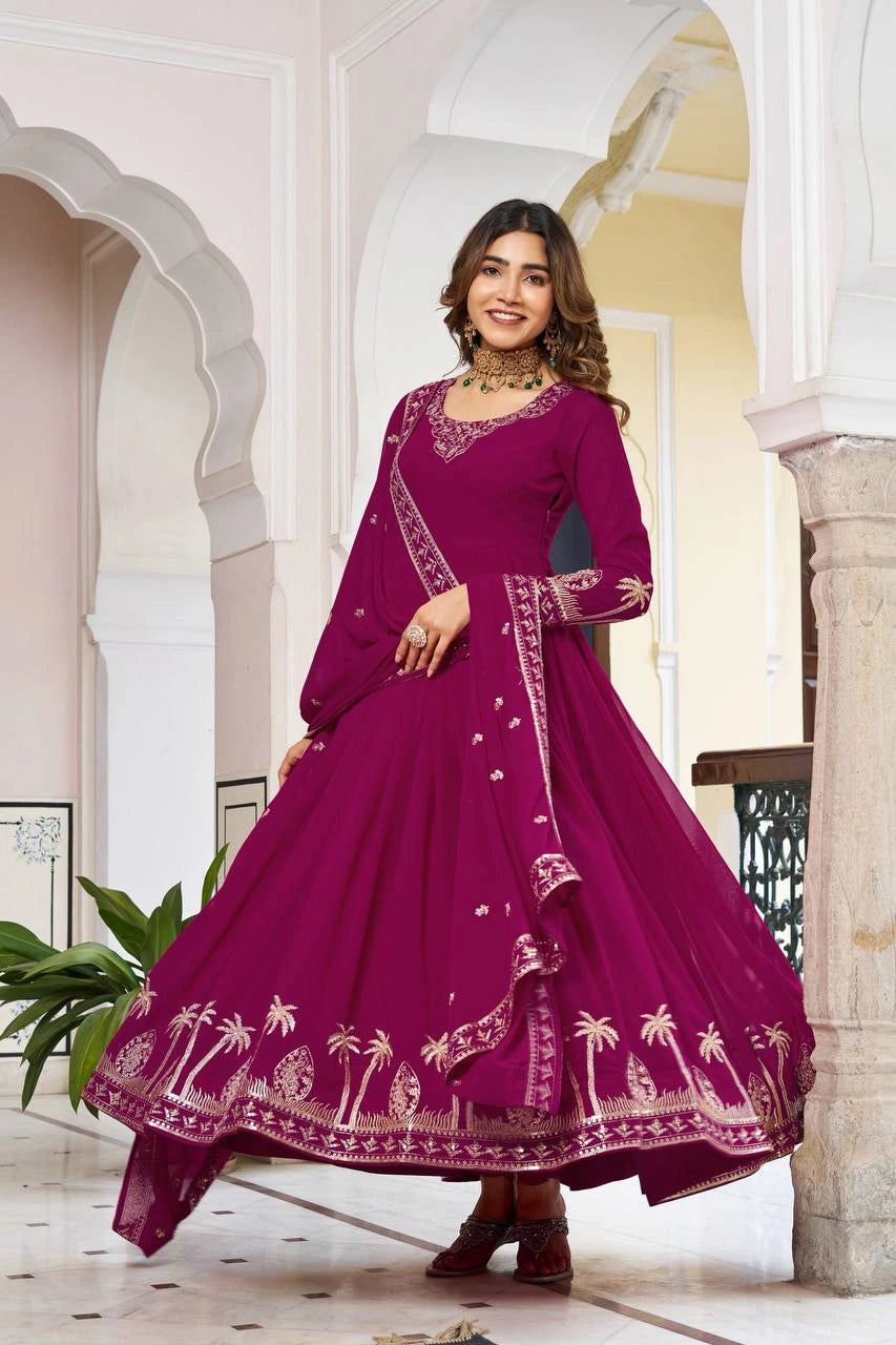 A full-length image of the woman twirling, showcasing the massive volume and pleated flare of the magenta Georgette fabric. The gold embroidery at the hemline creates a shimmering circular pattern as the dress moves.