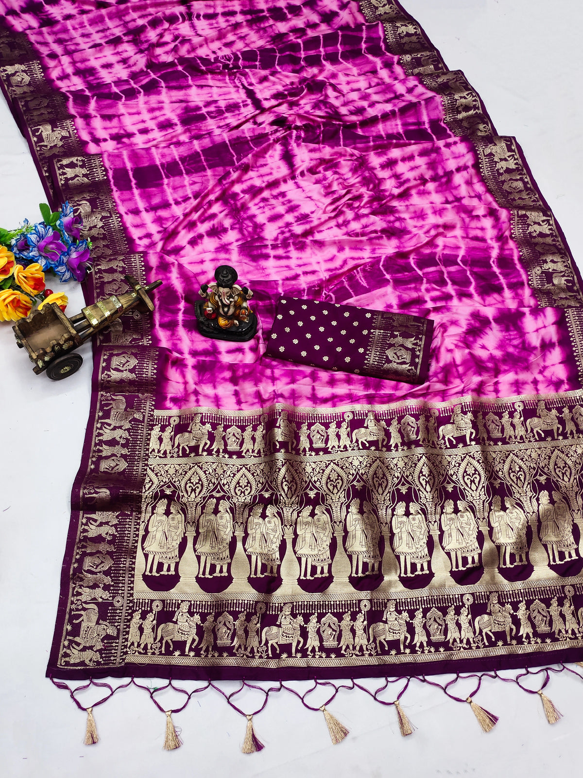 Pink and purple saree with elephant patterns on a white background