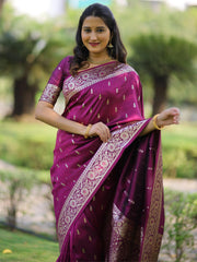 Woman wearing a purple saree with a floral blouse in an outdoor setting