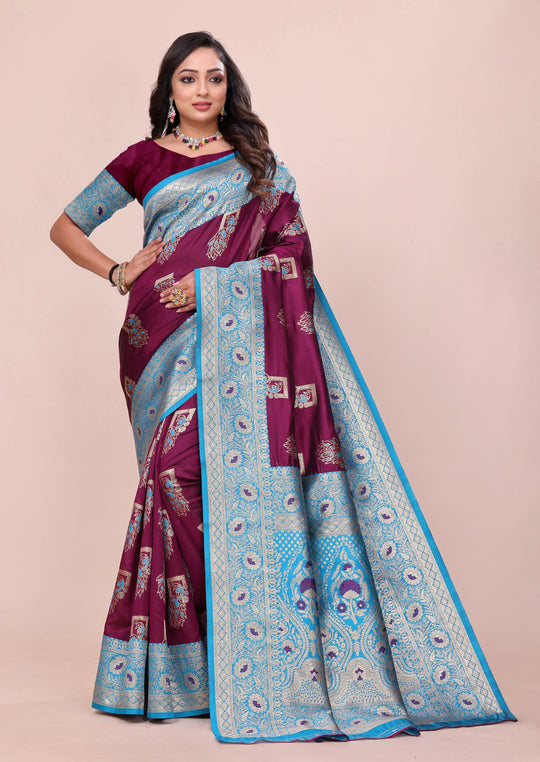 Woman wearing a maroon and blue saree with a beige background