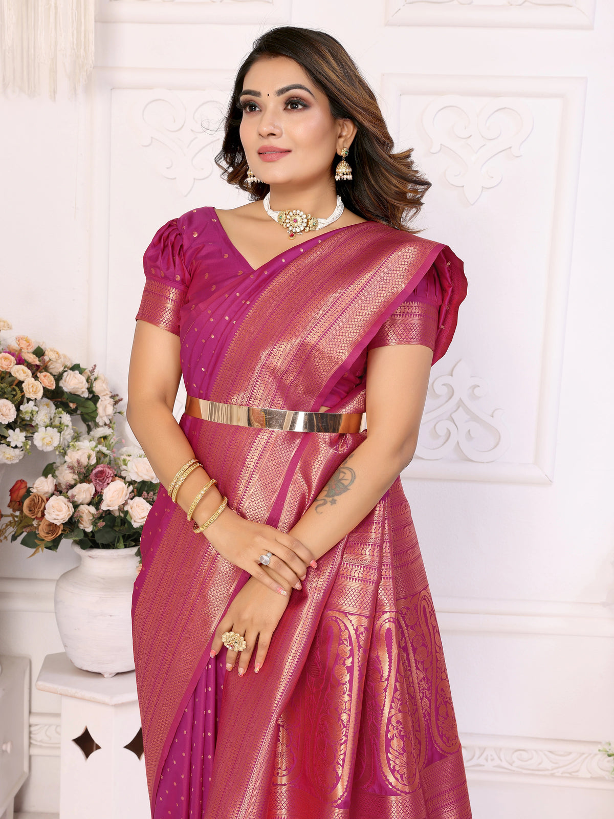 Woman wearing a pink saree with a white background