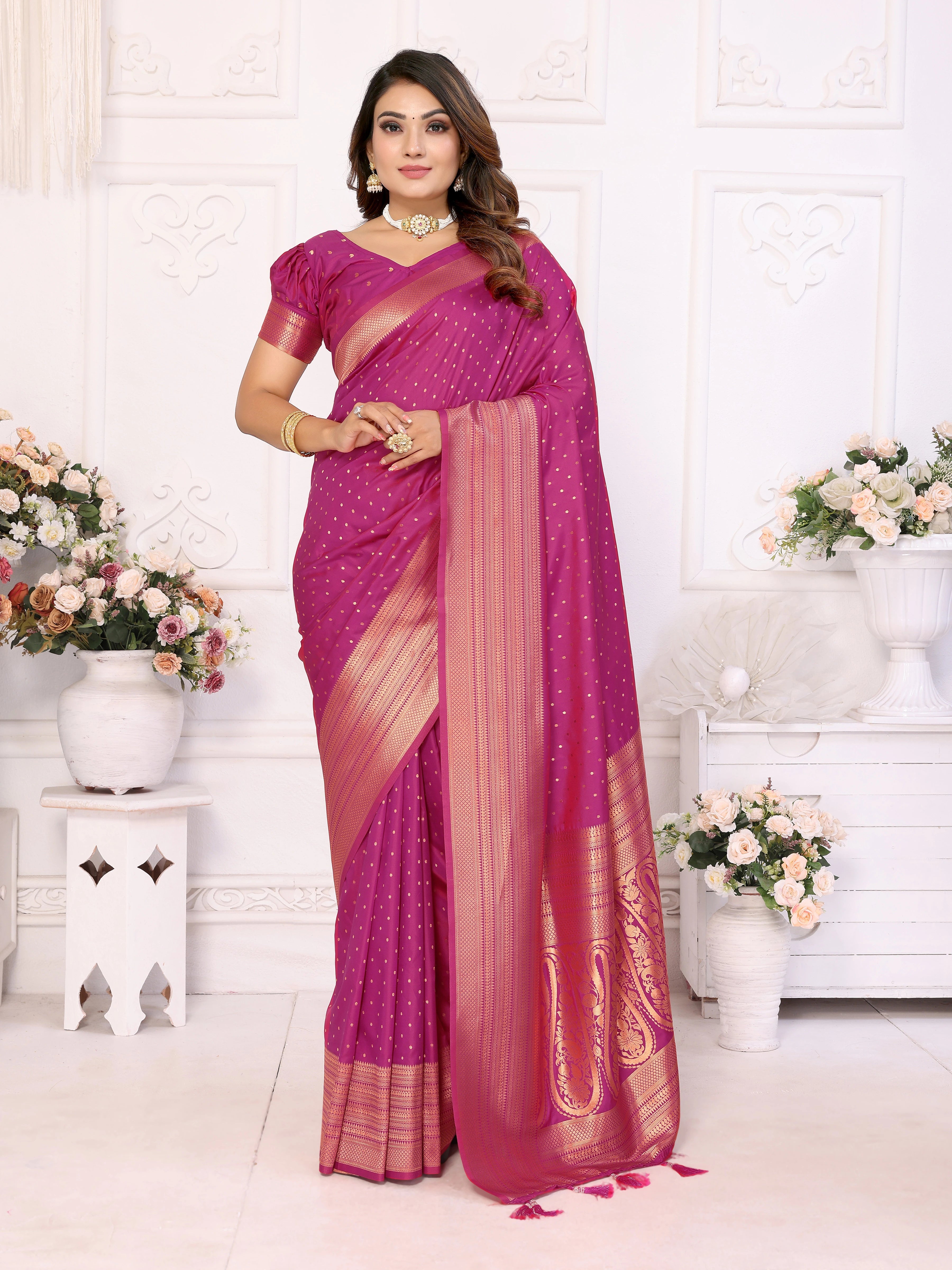 Woman wearing a pink saree with a white background