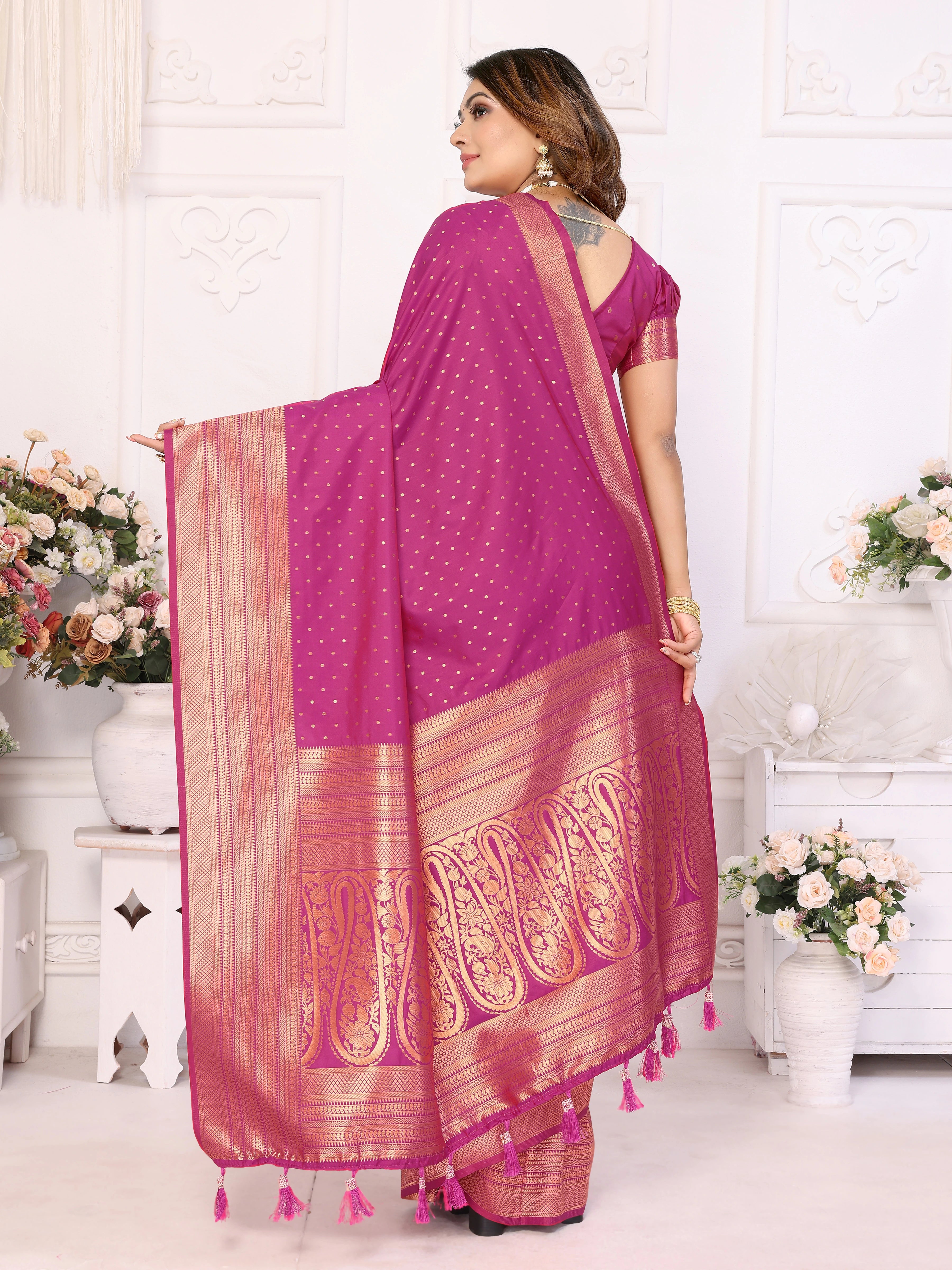 Woman wearing a pink saree with a white background