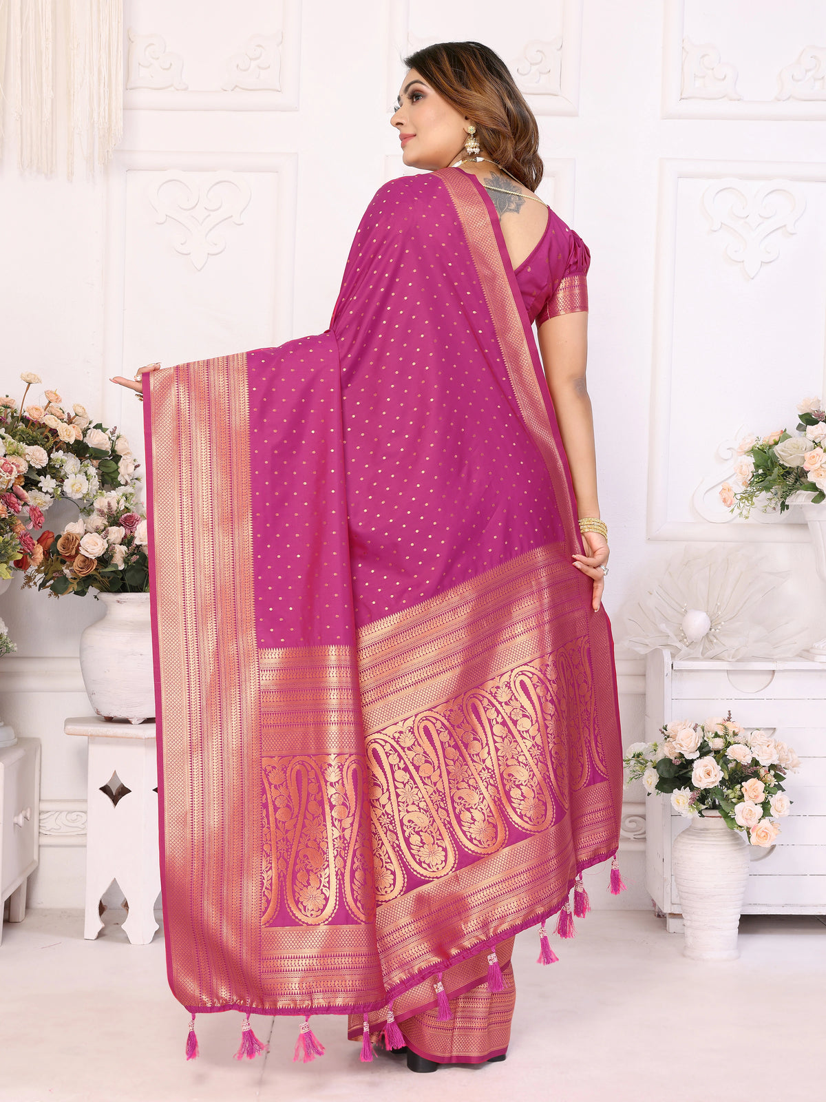 Woman wearing a pink saree with a white background