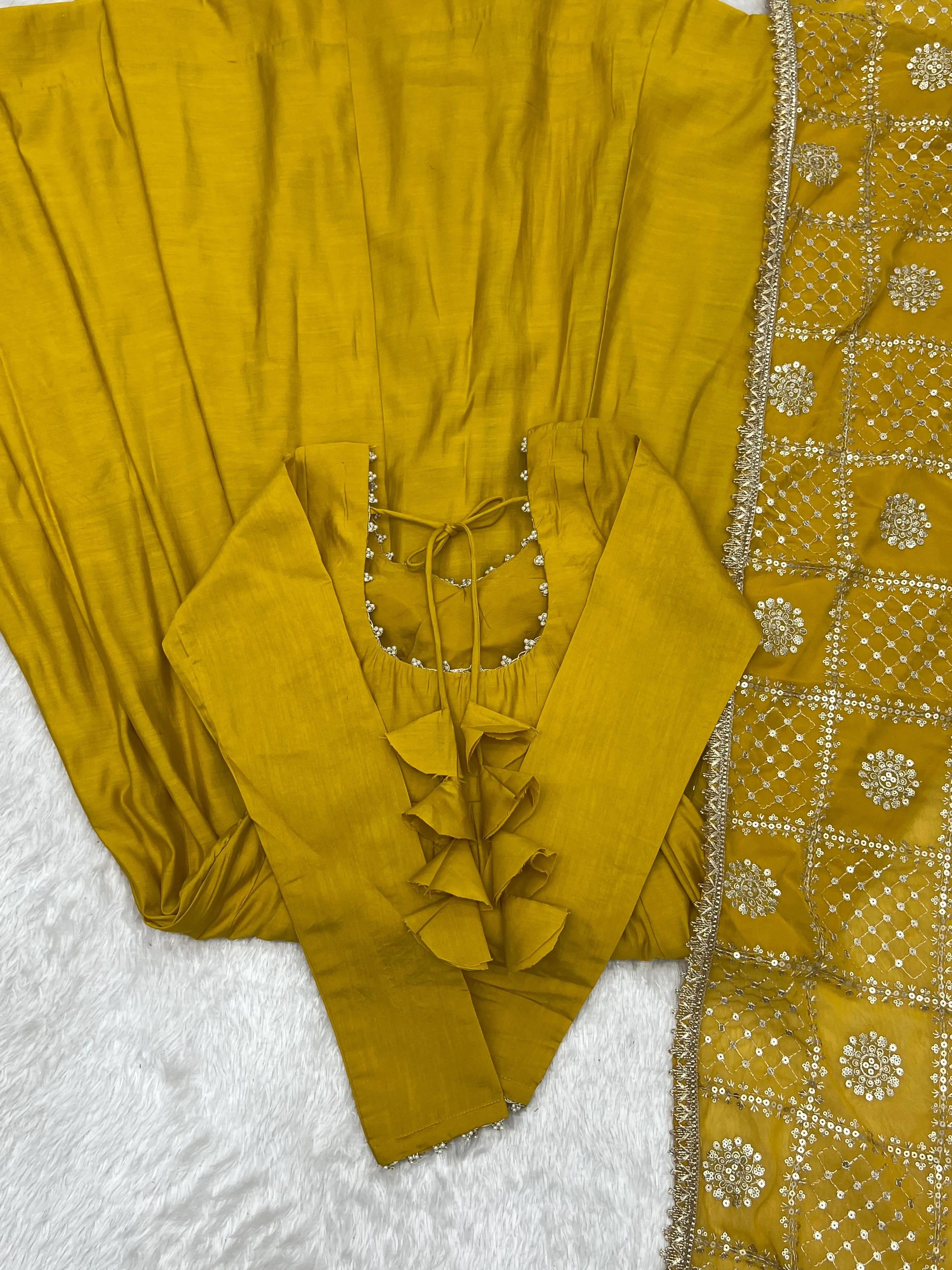 Flat lay of Yellow Sequins Embroidered Anarkali Suit showing ruffle back detail and pant