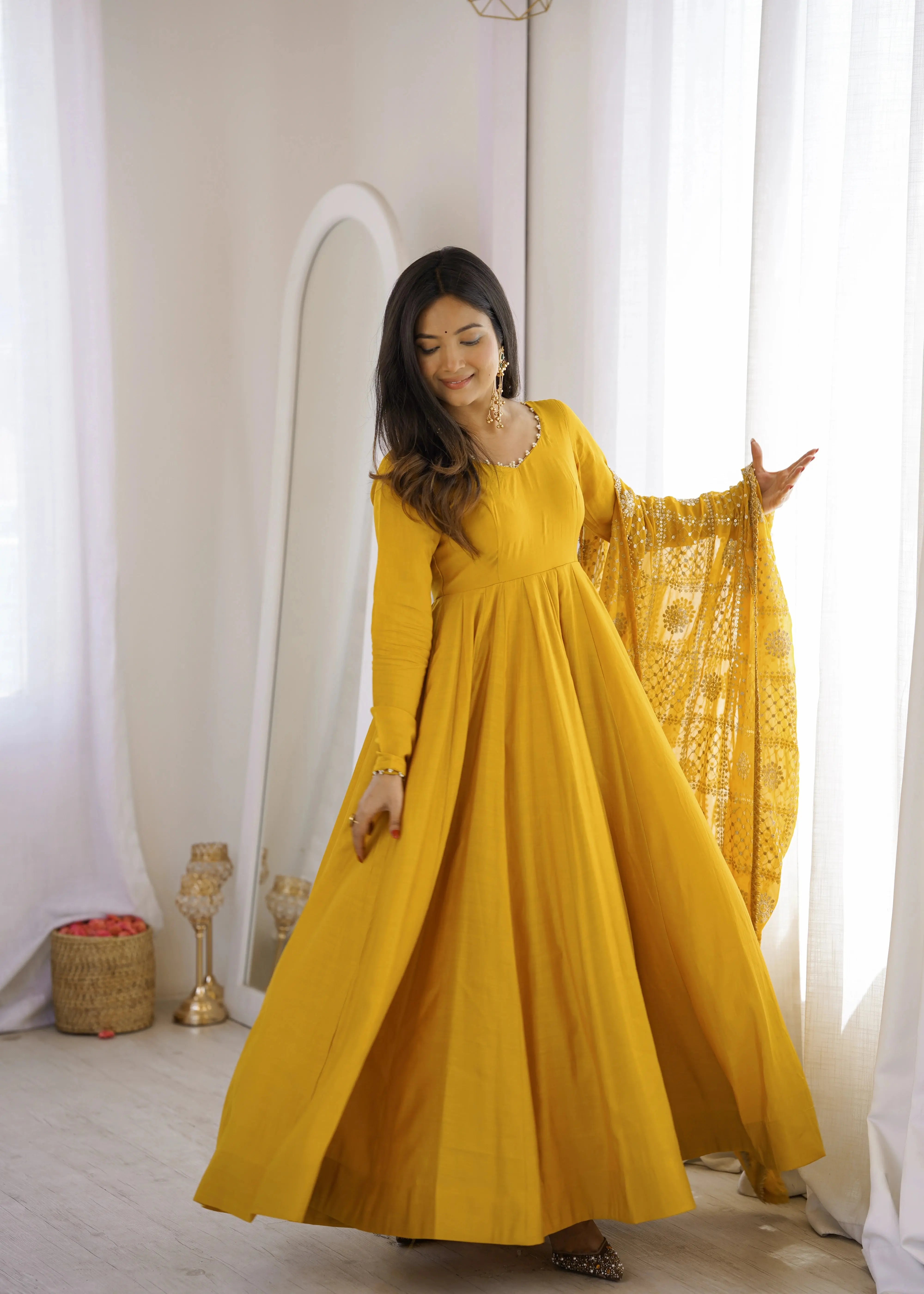 Yellow Sequins Embroidered Anarkali Suit model twirling with embroidered dupatta extended