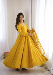 Yellow Sequins Embroidered Anarkali Suit side view model holding embroidered dupatta
