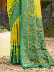 Green and yellow saree with intricate patterns on a natural background