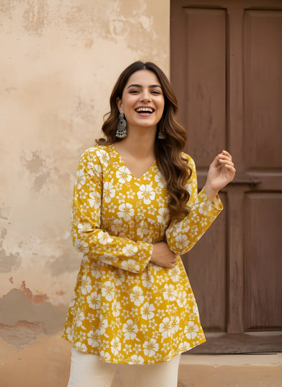 A candid medium shot of the woman laughing heartily. The image emphasizes the comfortable fit of the long sleeves and the cheerful aesthetic of the floral print.