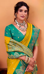 Woman wearing a green and yellow saree with jewelry against an orange background
