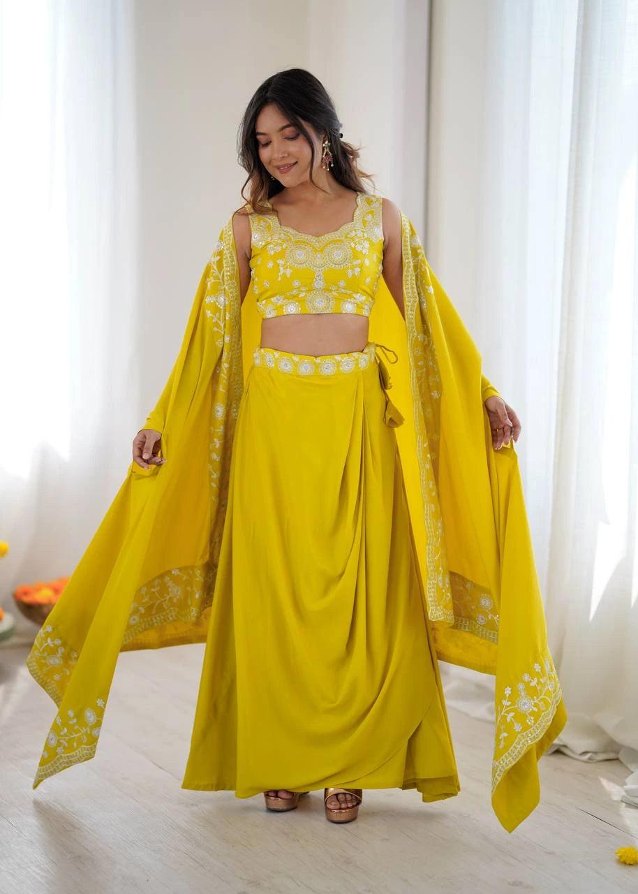Woman wearing a bright yellow traditional outfit with a matching dupatta in a well-lit room.