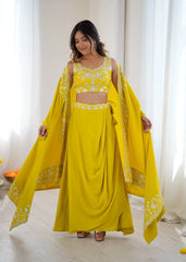Woman wearing a bright yellow traditional outfit with a matching dupatta in a well-lit room.