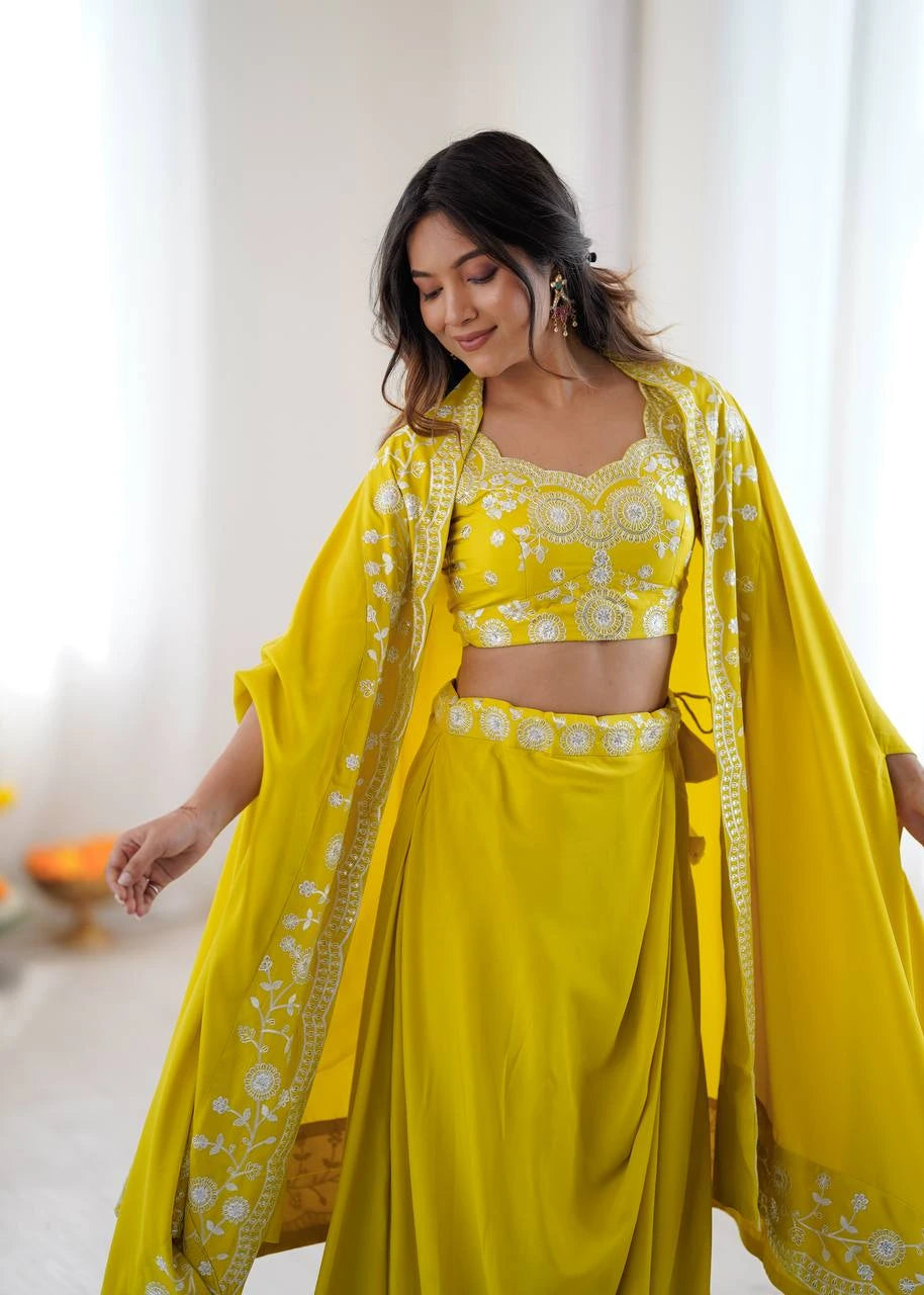 Woman wearing a yellow traditional outfit with a matching dupatta indoors.