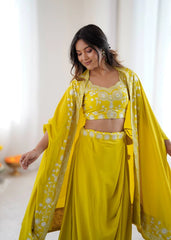 Woman wearing a yellow traditional outfit with a matching dupatta indoors.