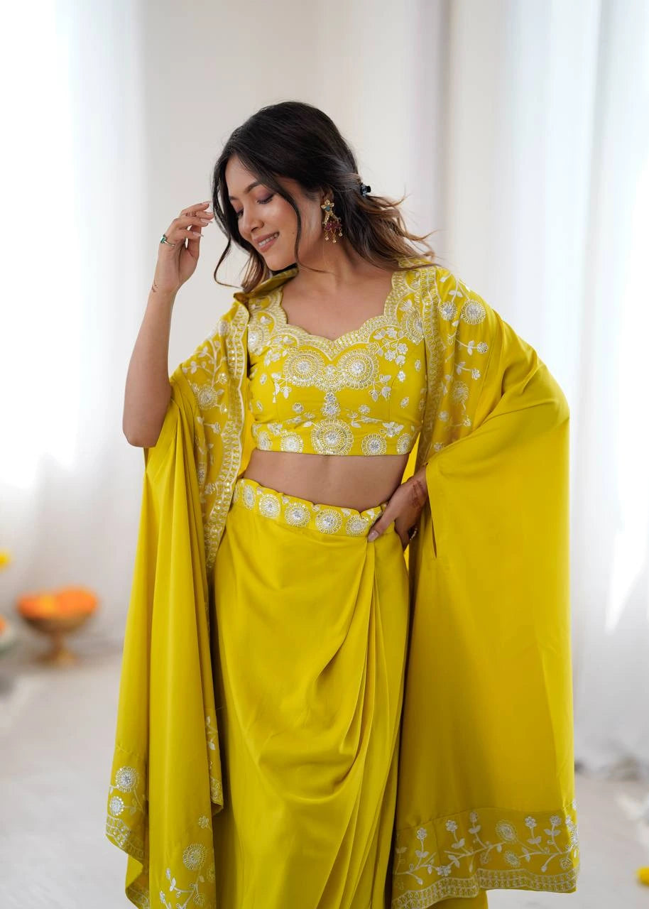 Woman wearing a bright yellow traditional outfit with floral patterns indoors.