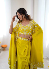 Woman wearing a bright yellow traditional outfit with floral patterns indoors.