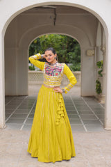 Woman in a yellow traditional outfit standing under an archway.