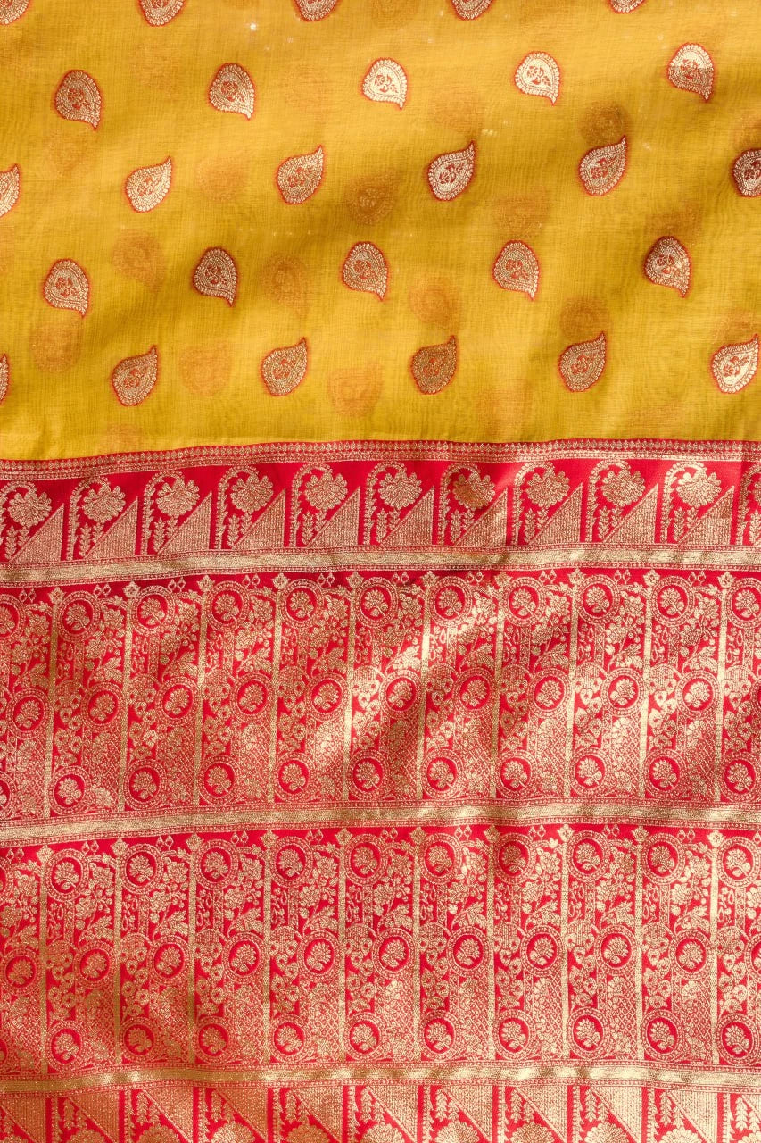 Traditional yellow and red fabric with intricate patterns