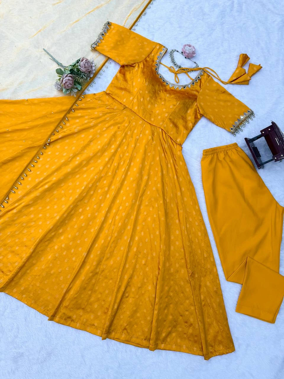 Mustard yellow traditional outfit with matching pants on a light blue background