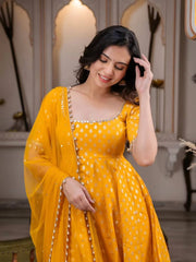 Woman wearing a yellow dress with a matching dupatta in an indoor setting
