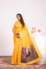 Woman wearing a yellow saree with a peacock design on a white background
