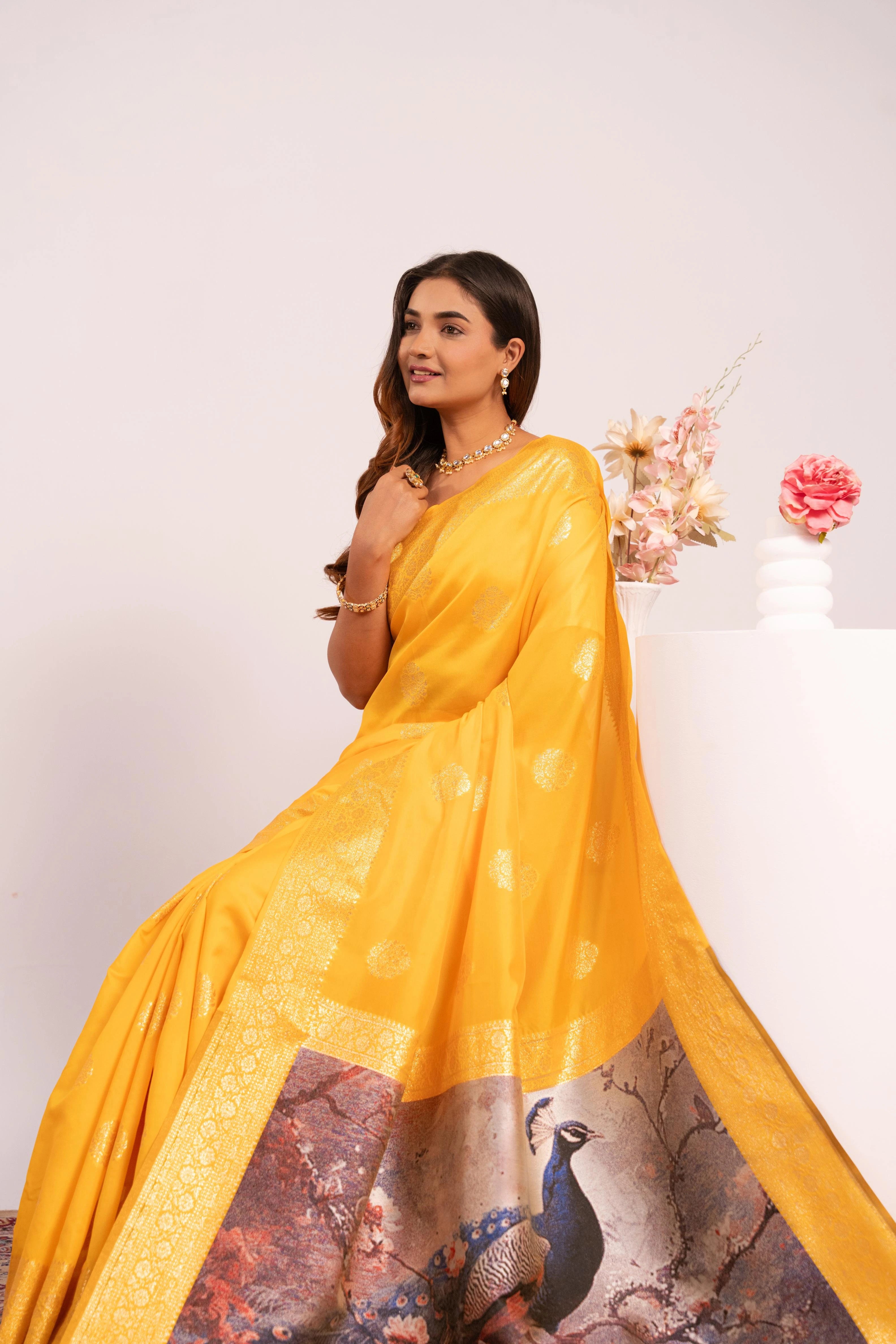 Woman wearing a yellow saree with a white background