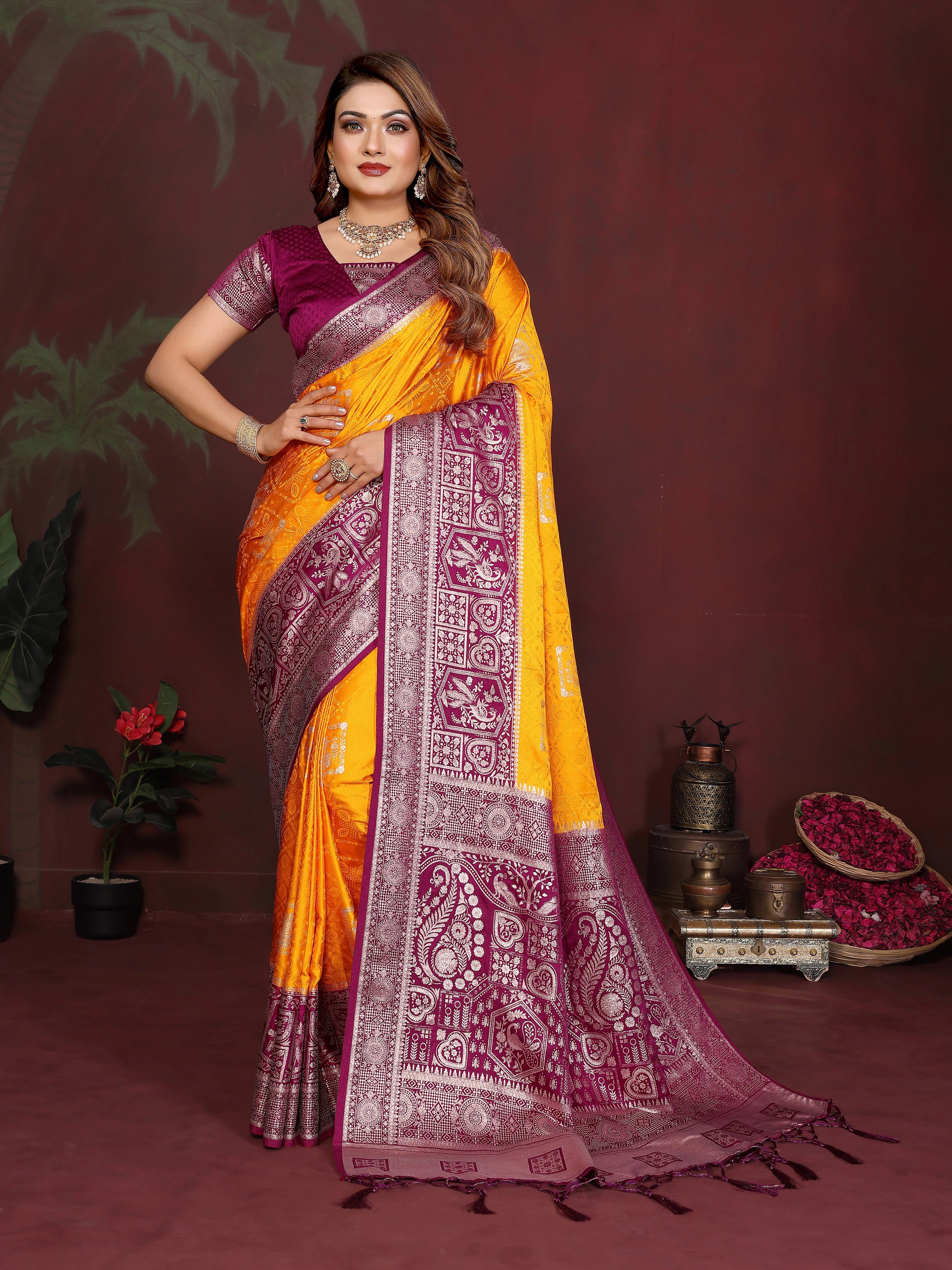 Woman wearing a yellow and purple saree with a dark background