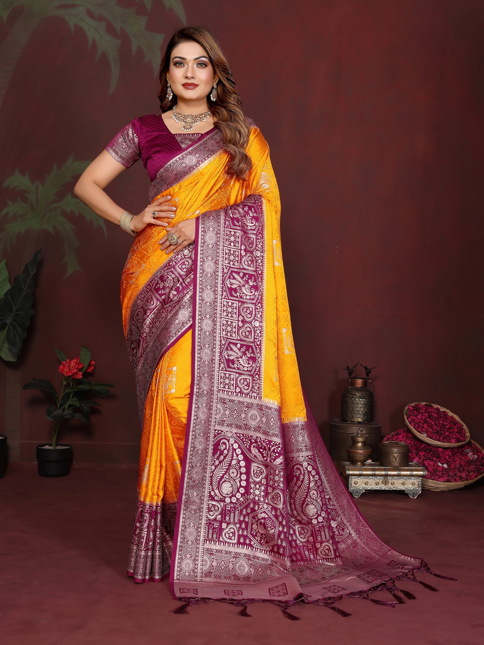 Woman wearing a yellow and purple saree with a dark background