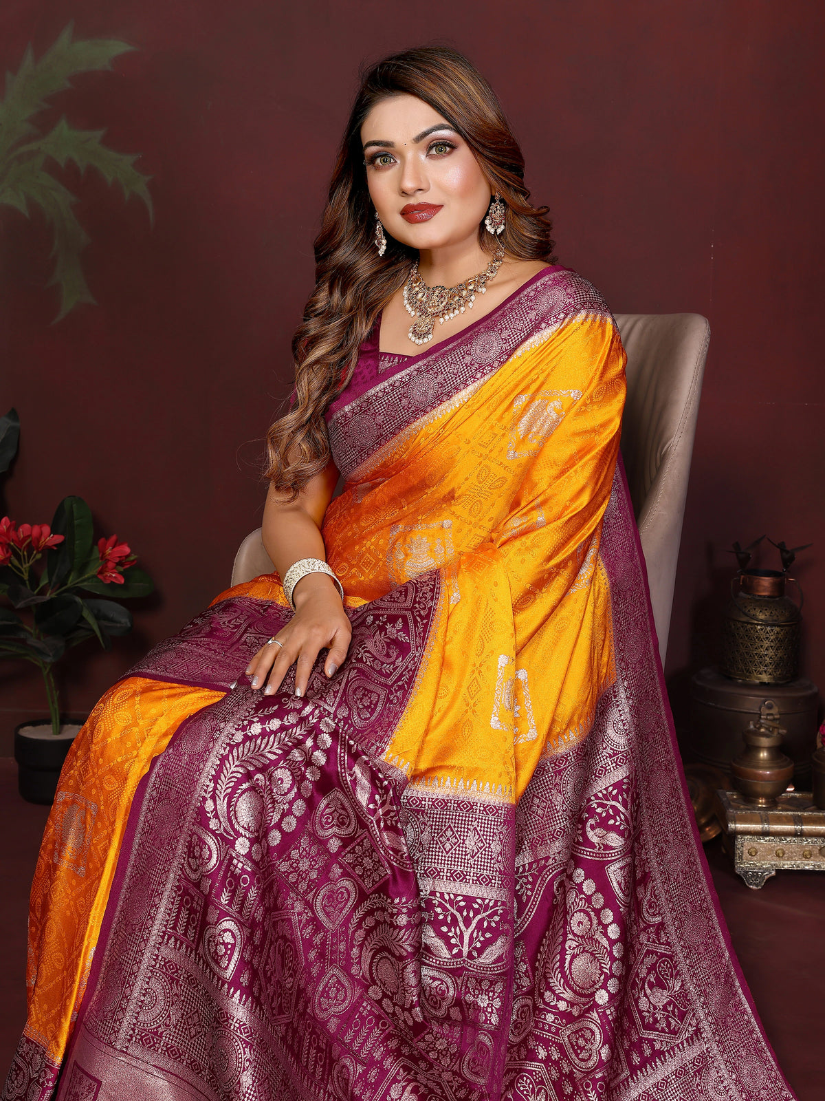 Woman wearing a yellow and purple saree with a dark background