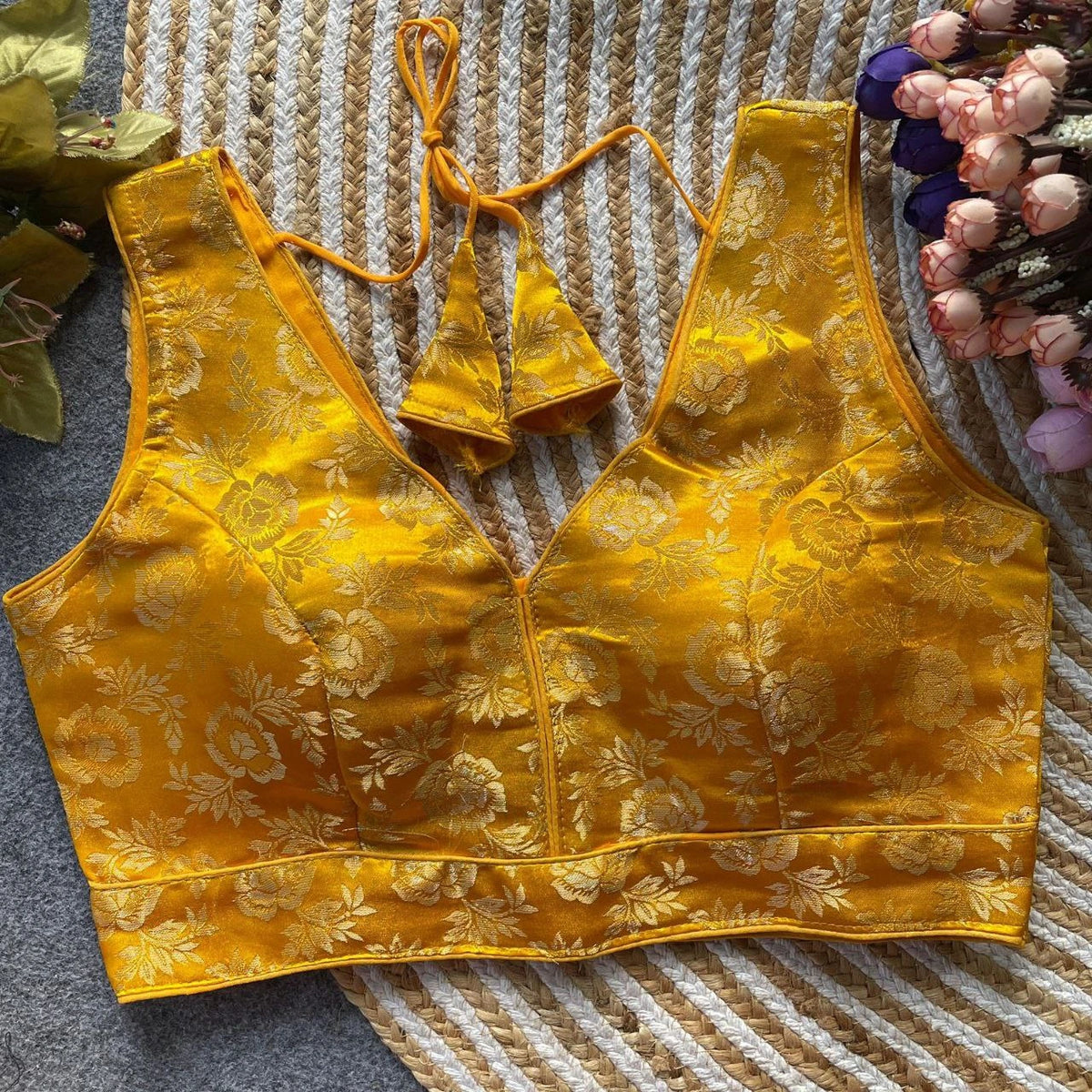 Yellow floral-patterned bralette on a textured surface