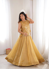 Woman wearing a yellow traditional outfit with a white curtain background