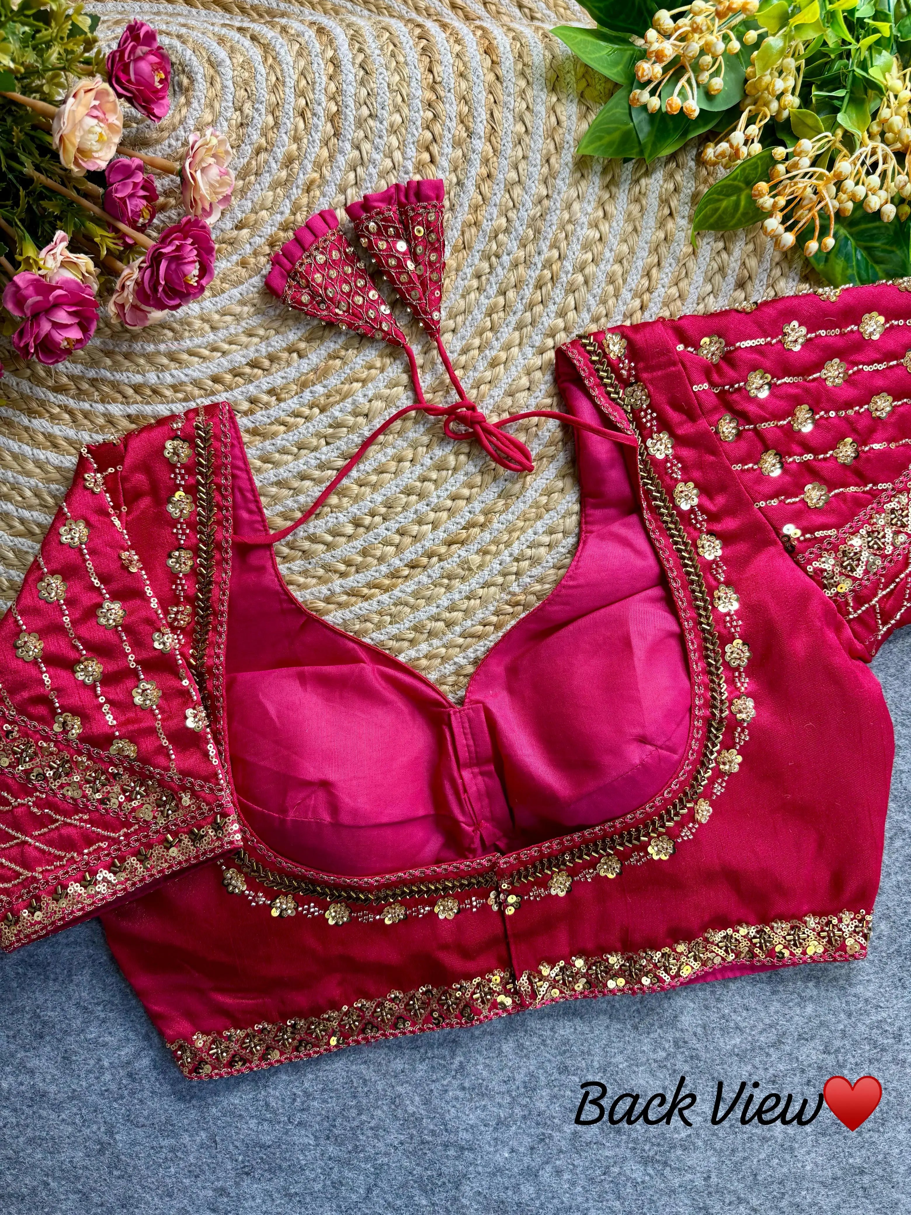 Dark pink fabric with intricate sequence and codding thread work design, displayed in a side view.