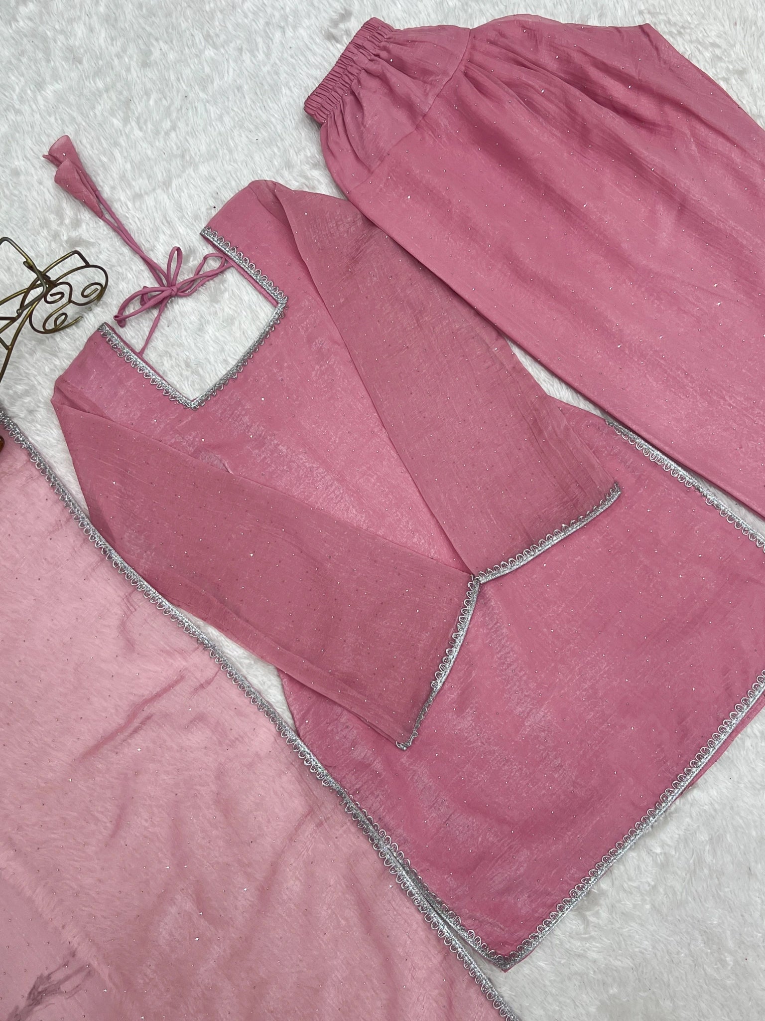 Baby pink suit flat lay - back tie-up detail