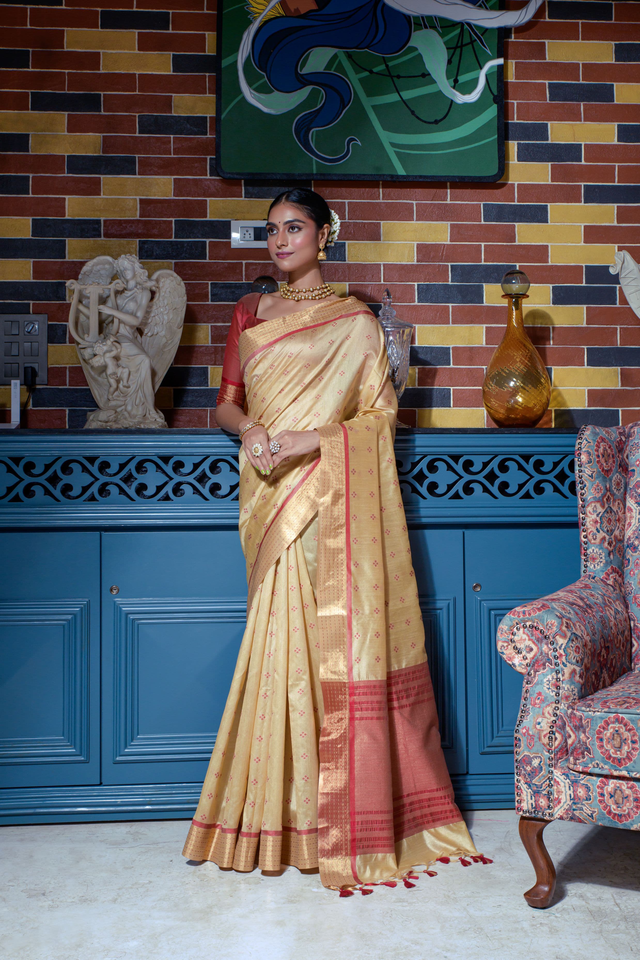 Beige saree with zari work and red border