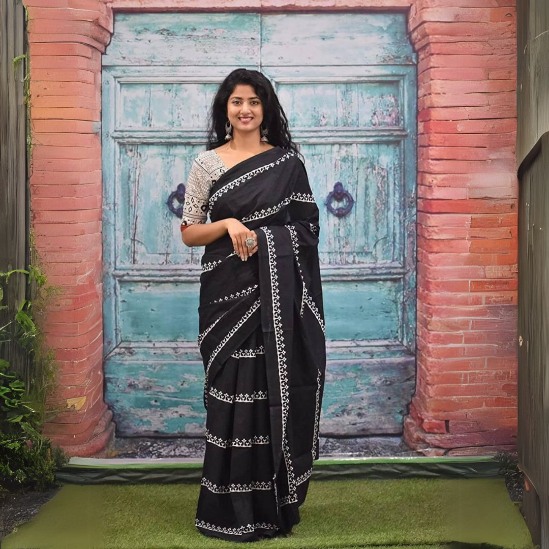 Woman wearing a black Jaipur block print saree with intricate white motifs, paired with printed blouse